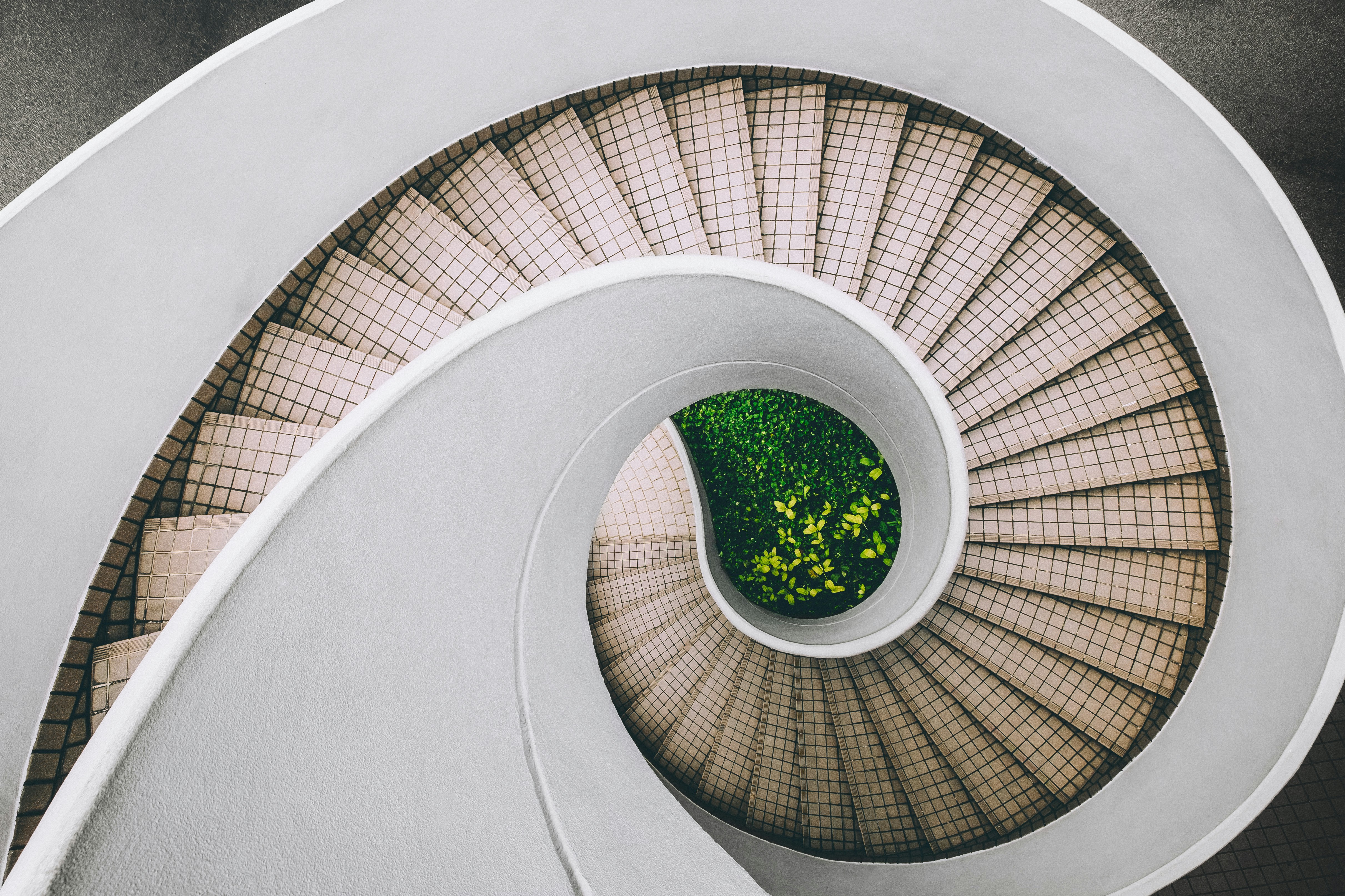 white and brown concrete spiral stairs